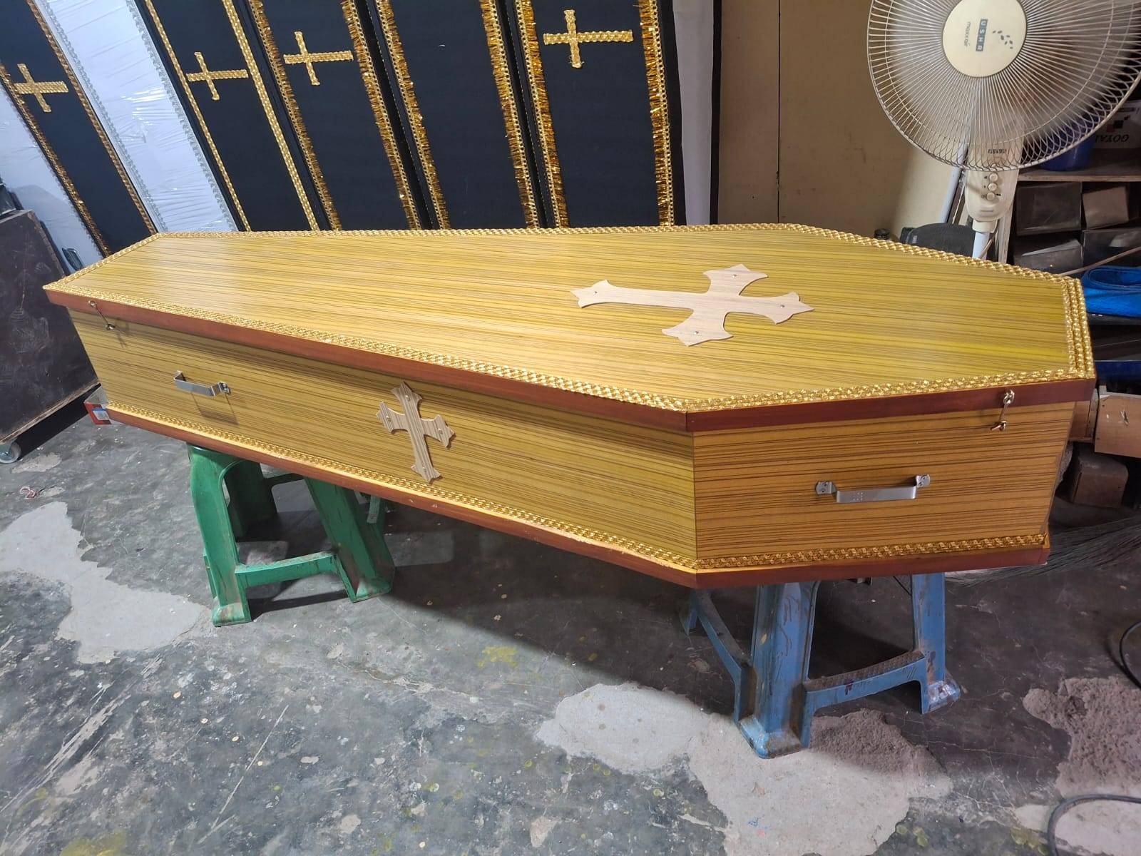 Golden wooden coffin with cross