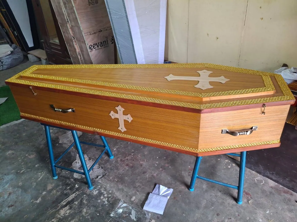 Light wooden coffin with carved cross inlay
