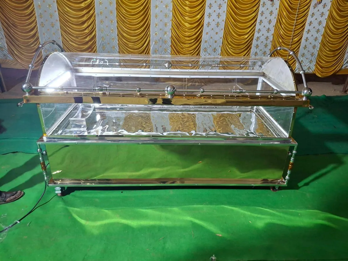 Mortuary viewing casket with glass panels and polished trim