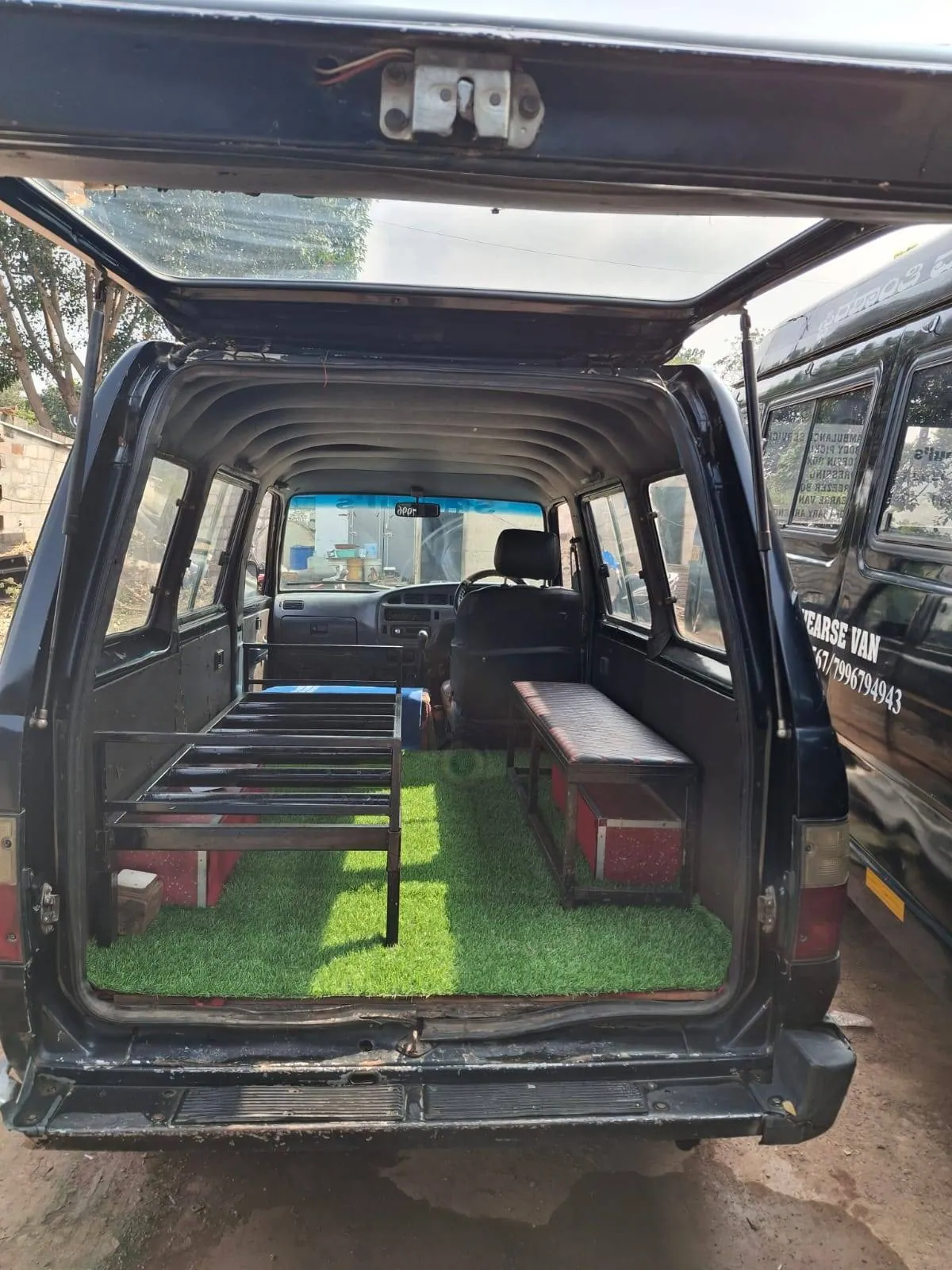 Hearse interior with coffin platform and side seating