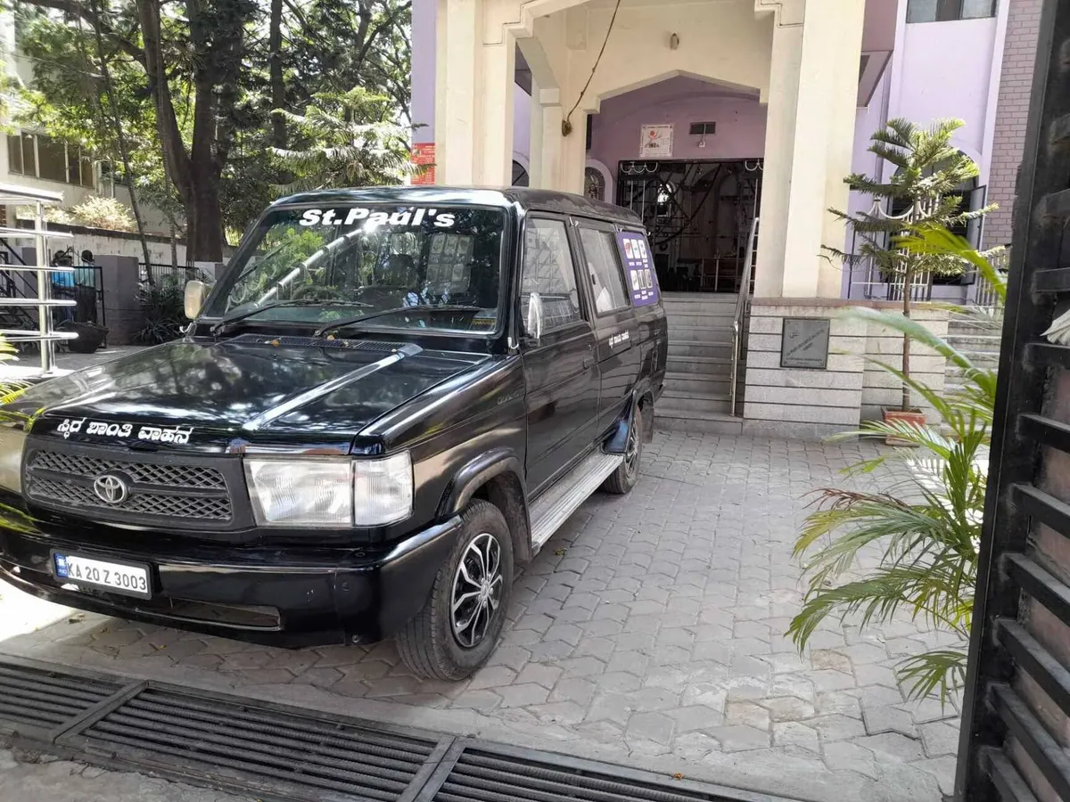 St Paul's Funeral Undertakers vehicle outside a church in Bangalore